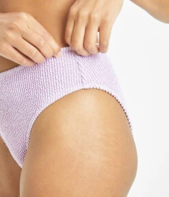 The Swim Ruched High Waist Bikini Bottom: Lilac -Outlet No Wire Bras Store 4 on model side1 swim ruched high waist bikini bottom lilac